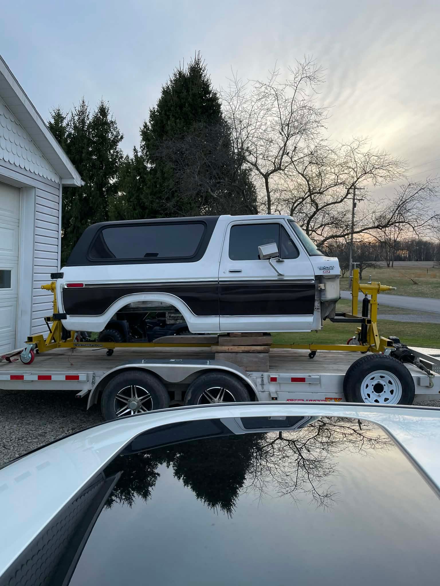 Ford Bronco body on a restoration rotisserie and trailer
